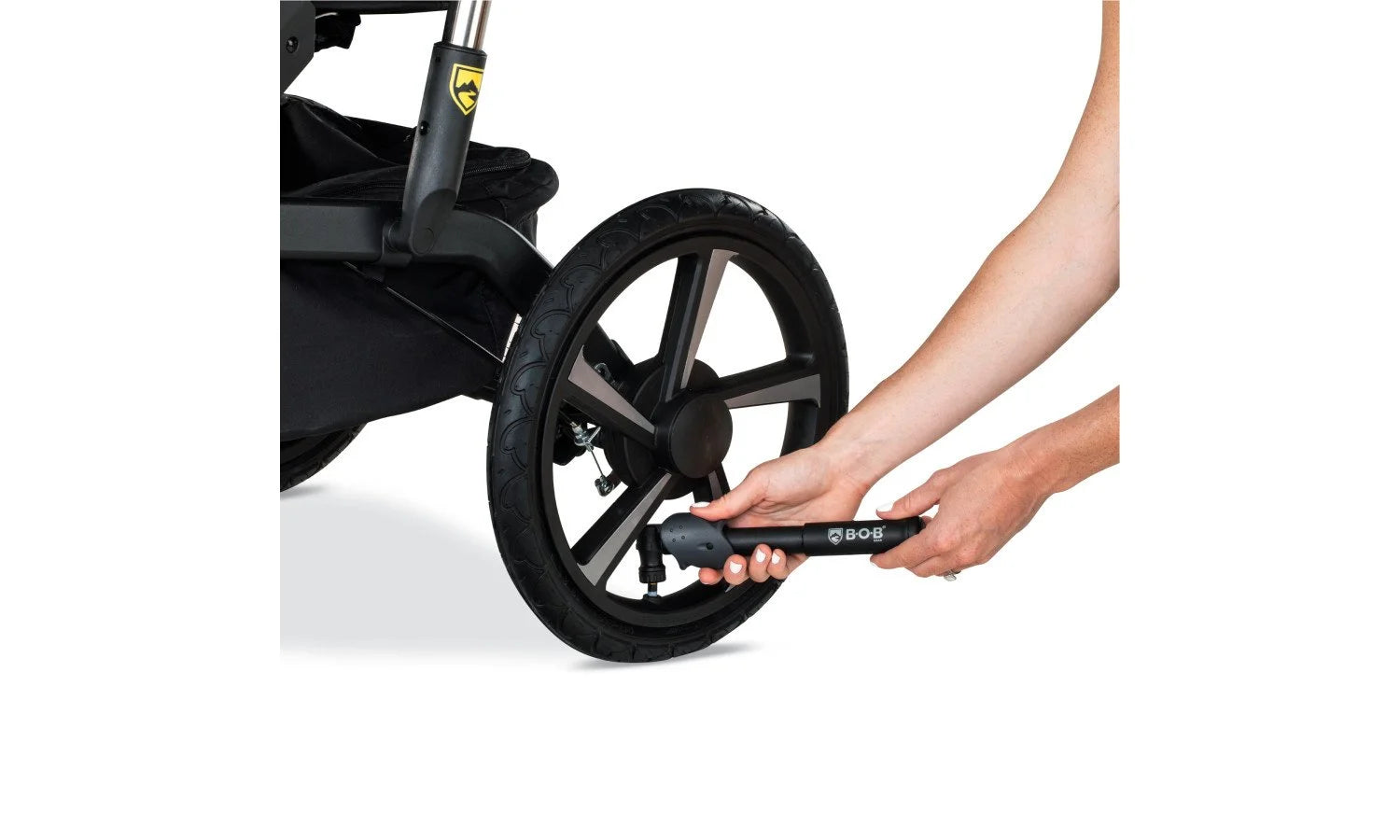 Person Using Tire Pump on Alterrain Pro Jogging Stroller