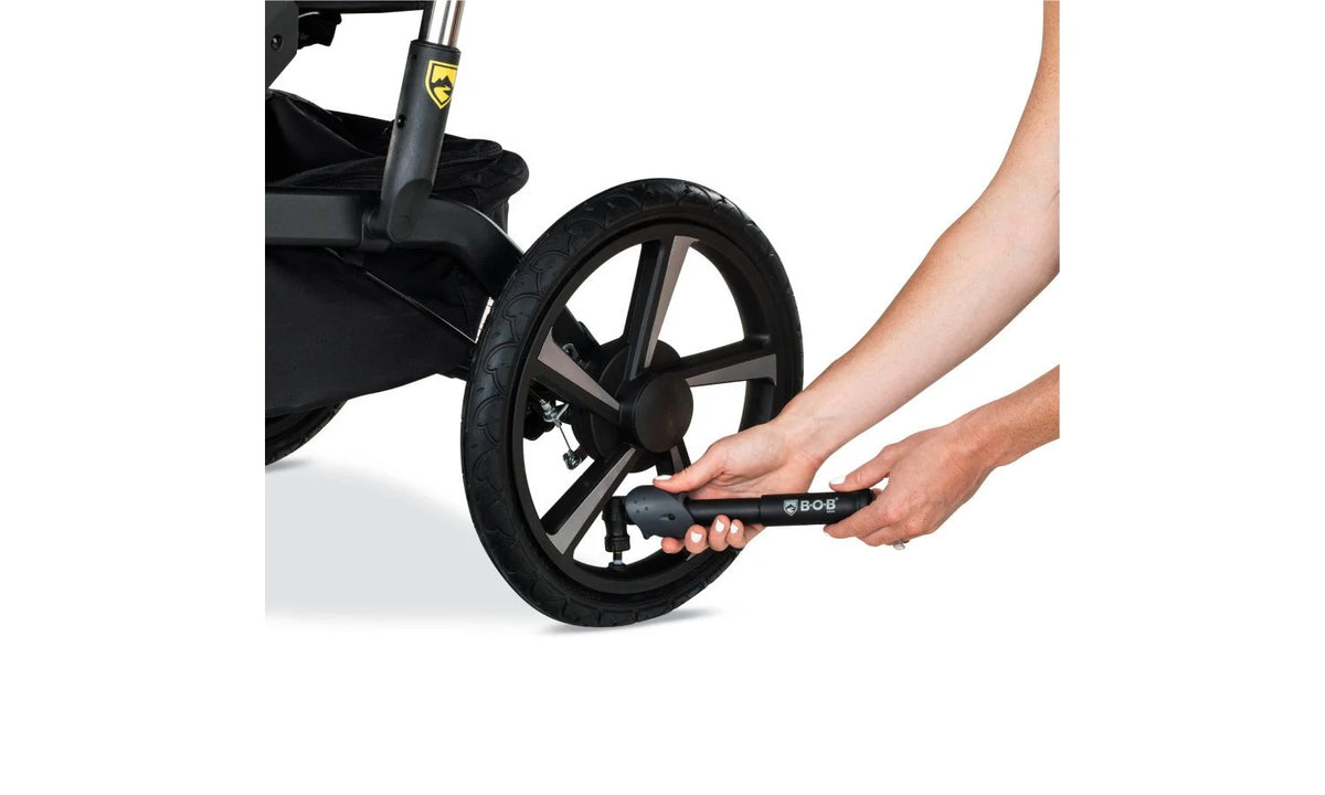 Person Using Tire Pump on Alterrain Pro Jogging Stroller