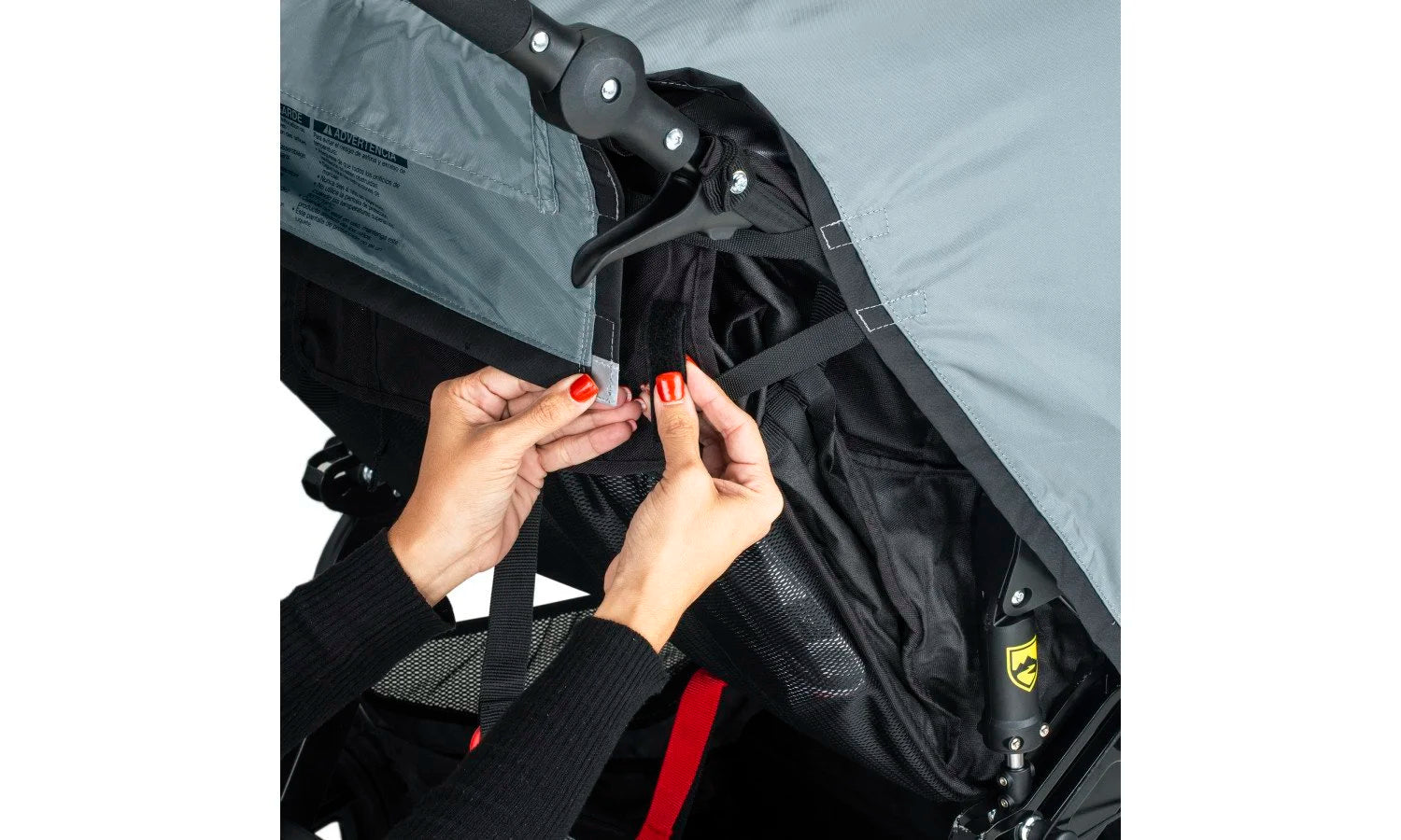 Attaching the Weather Shield to the jogging stroller using velcro