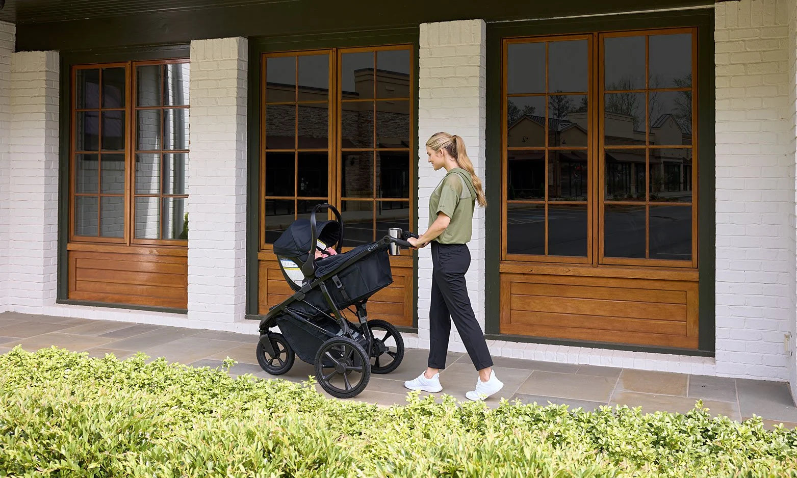 Mother pushing her wayfinder pack travel system with baby inside